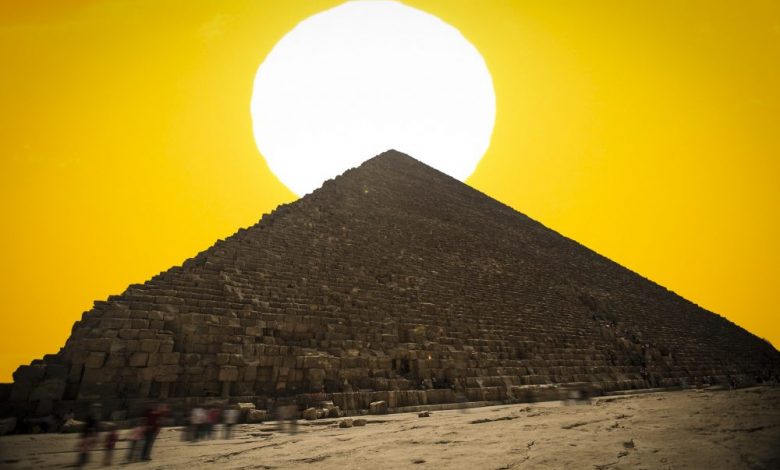 An image of the Great Pyramid of Giza with the Sun in the background. Shutterstock.