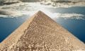 The Great Pyramid of Giza and people climbing its supermassvie stones. Shutterstock.