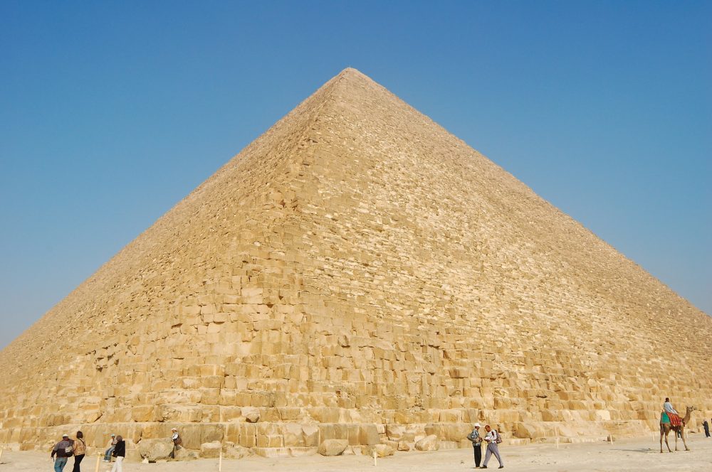 People standing in front of the Great Pyramid at Giza. Shutterstock.