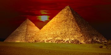 An image of the Egyptian pyramids and the sunset in the background. Shutterstock.