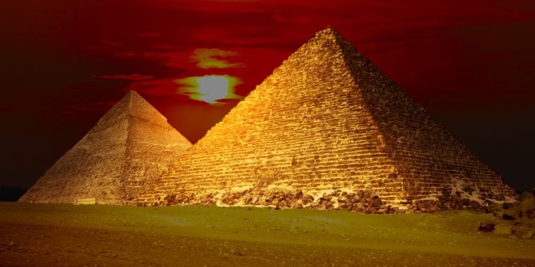 An image of the Egyptian pyramids and the sunset in the background. Shutterstock.