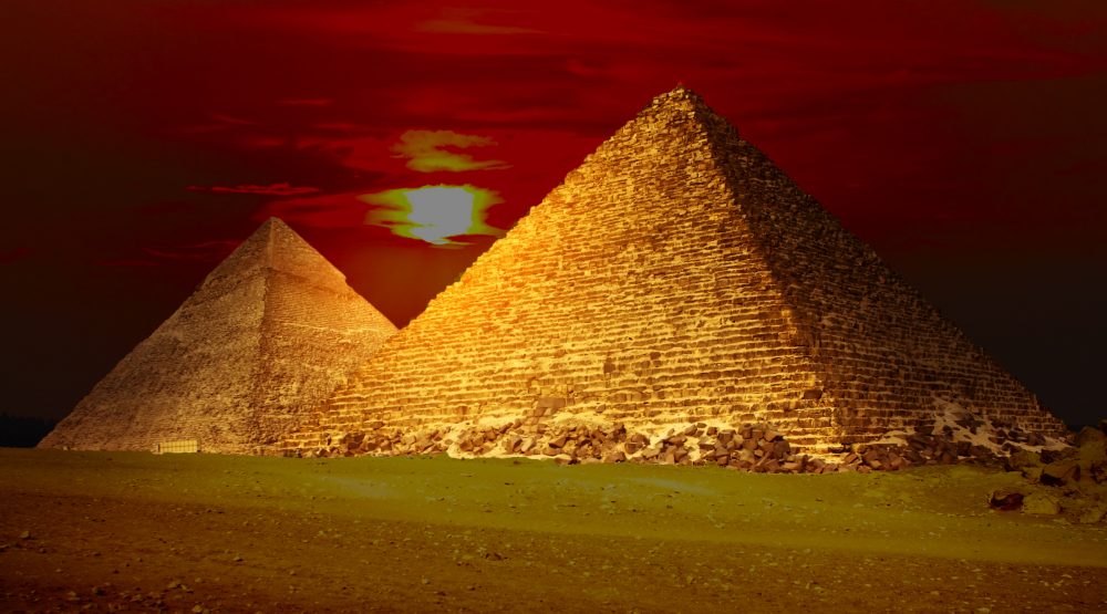 An image of the Egyptian pyramids and the sunset in the background. Shutterstock.