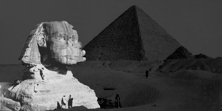 The Great Sphinx with the Pyramid of Pharaoh Cheops in the background. 1877 photo by French photographer Henri Bechard. Shutterstock.