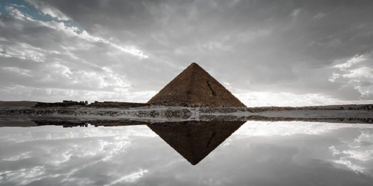 An image of an ancient Egyptian pyramid and its reflection. Shutterstock.