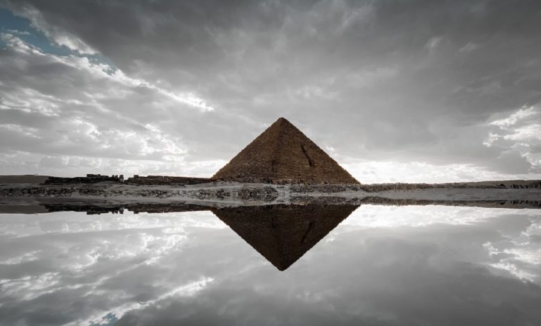 An image of an ancient Egyptian pyramid and its reflection. Shutterstock.