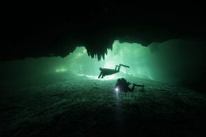 An image of Divers in the cenote Dreams Gate at Playa del Carmen in Mexico. Shutterstock.