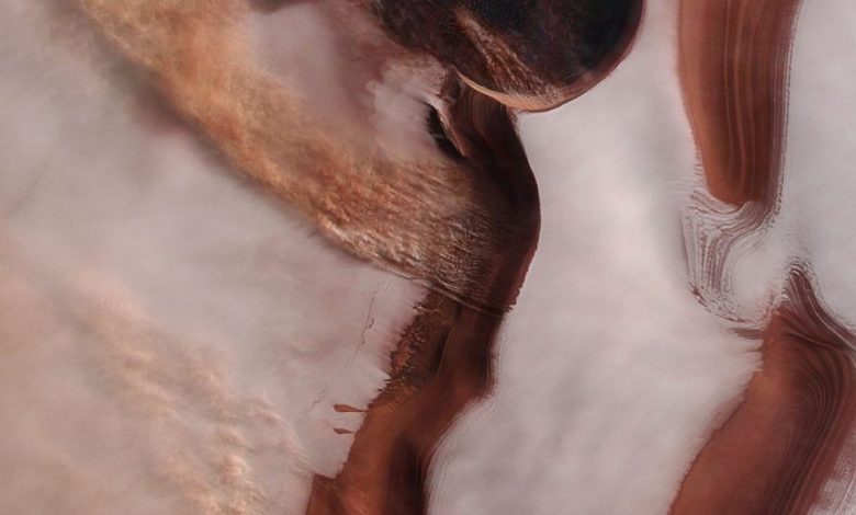 An image of the North Pole of Mars showing swathes of ice and strong winds. Image Credit: ESA.