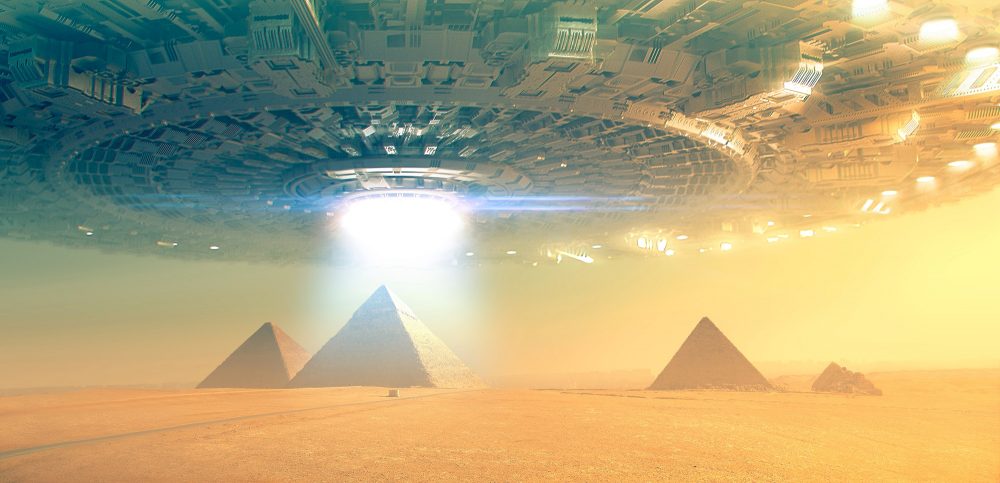 An artists rendering of a massive spaceships hovering above the ancient Egyptian pyramids at Giza. Shutterstock.