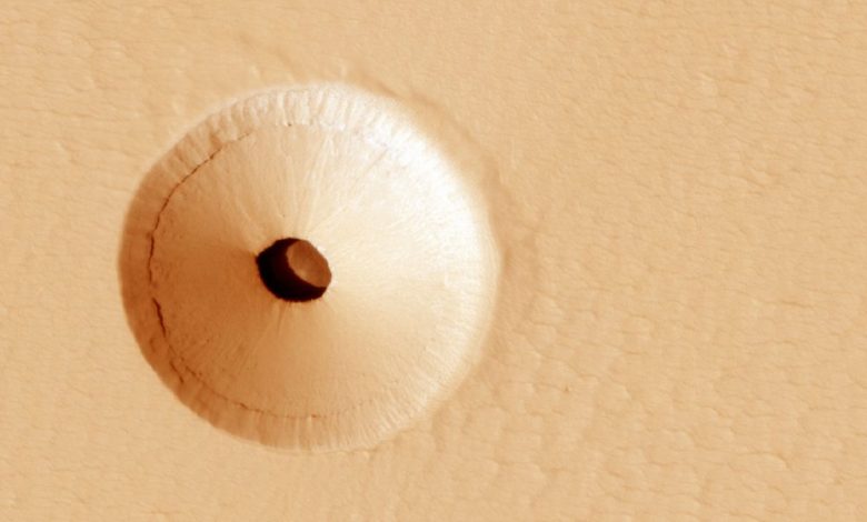 A NASA image showing a mysterious hole on the surface of Mars. Image Credit: MRO / NASA.