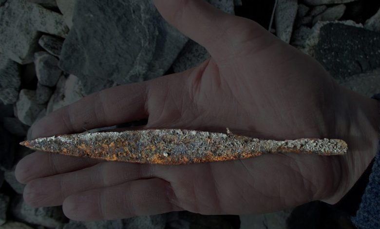 An image of the ancient Viking arrowhead being held by an archeologists in Norway. Image Credit: Secrets of the ice / Twitter.