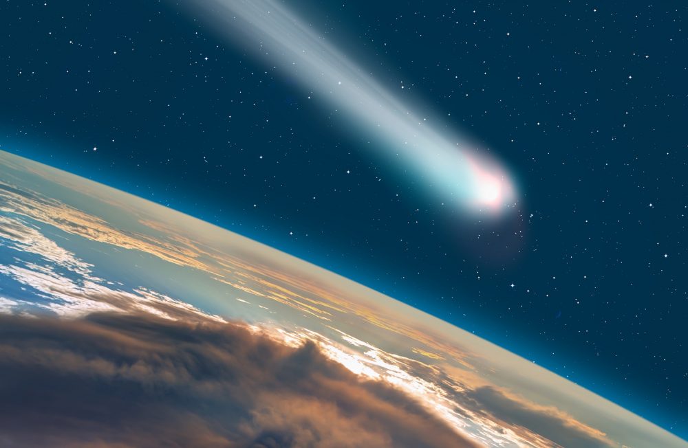 An artists rendering of a comet / asteroid passing next to Earth. Shutterstock.
