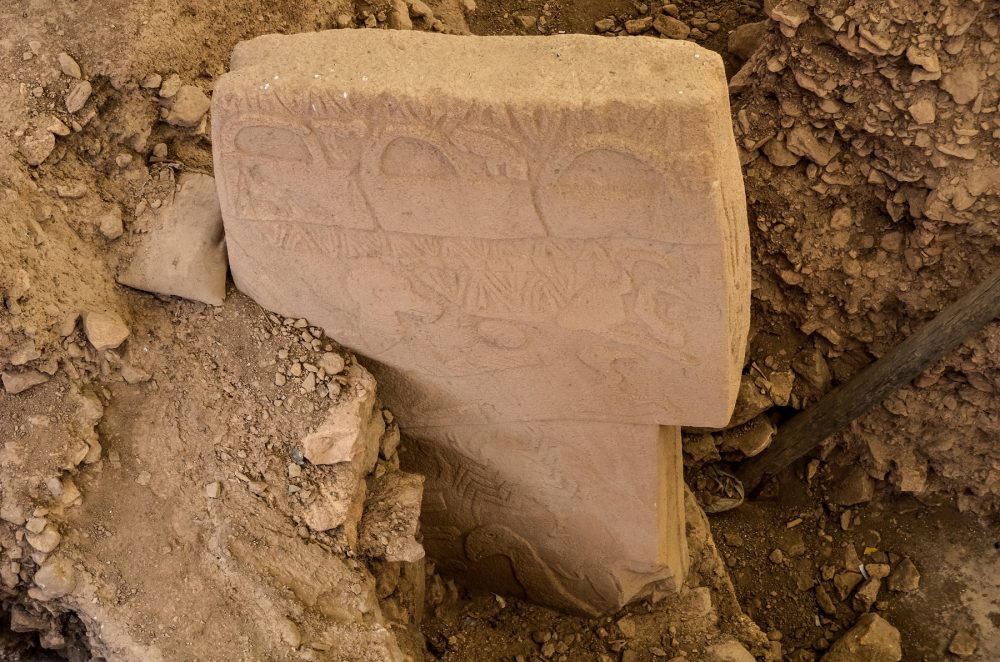 An image of a half-buried stone pillar at Gobekli Tepe. Shutterstock.