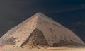 An image of the Bent Pyramid at Dahshur, and people circled in red standing next to the pyramid. Shutterstock