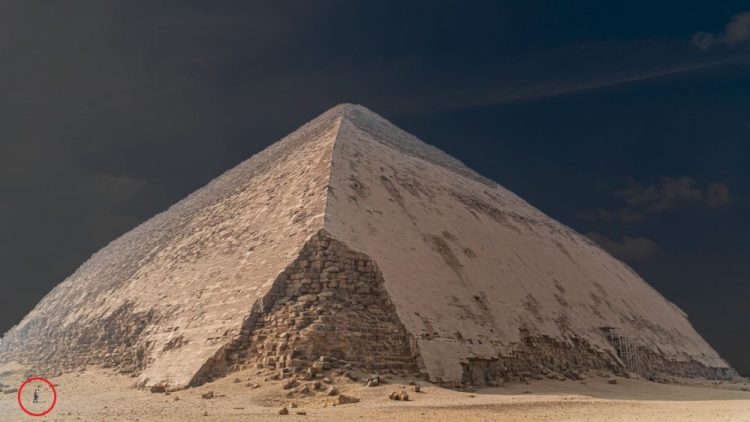 An image of the Bent Pyramid at Dahshur, and people circled in red standing next to the pyramid. Shutterstock