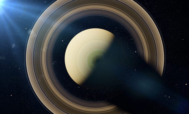 An image of Saturn, the sixth planet from the sun, illuminated by the Sun. Artist's rendering. Shuterstock.