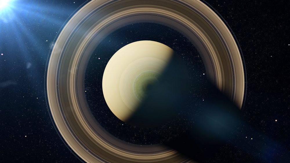 An image of Saturn, the sixth planet from the sun, illuminated by the Sun. Artist's rendering. Shuterstock.