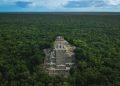 An aerial image of the Pyramid of Calakmul rising above the dense rain-forest beneath. Shutterstock.