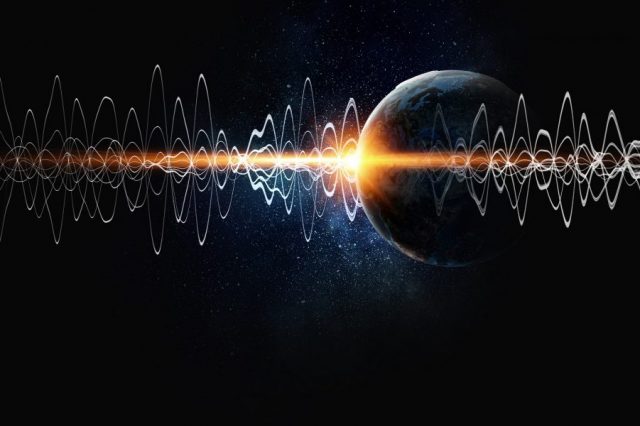 An artist's rendering of seismic waves and Earth in the background. Shutterstock.