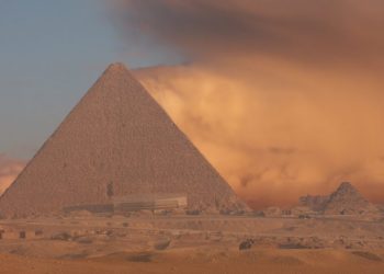 An image of the Great Pyramid of Giza with a sand storm in the background. Shutterstock.
