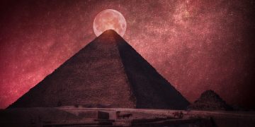 The Great Pyramid of Giza in front of a Full Moon. Shutterstock.
