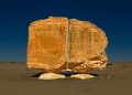 A unique view of the Al Naslaa Rock formation that appears to be split in half with laser like precision. Shutterstock.