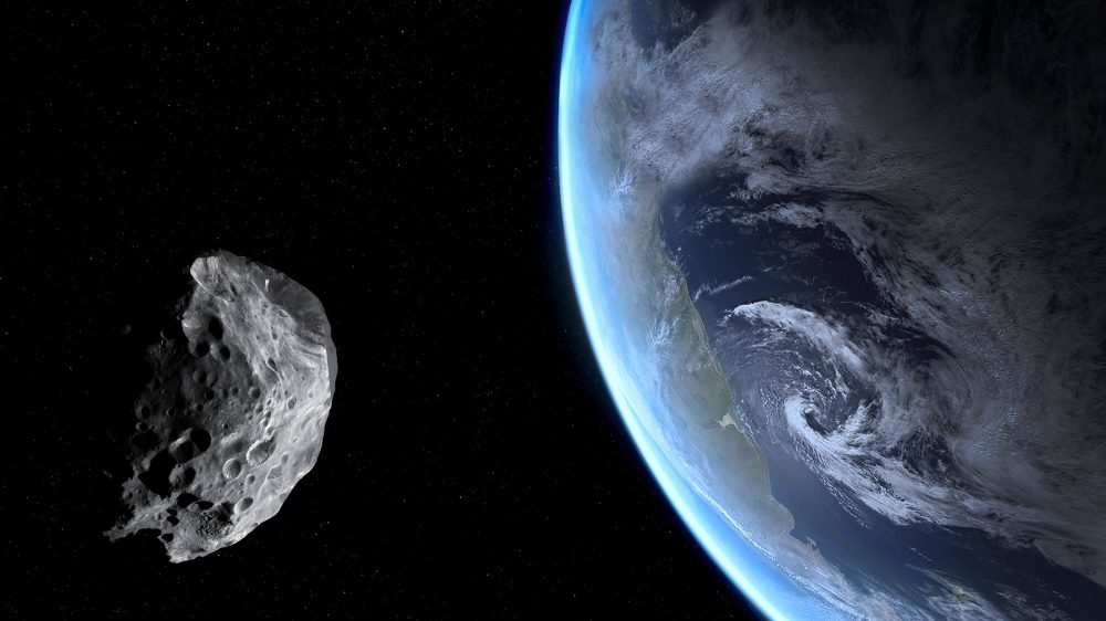 An asteroid in space and Earth. Shutterstock.