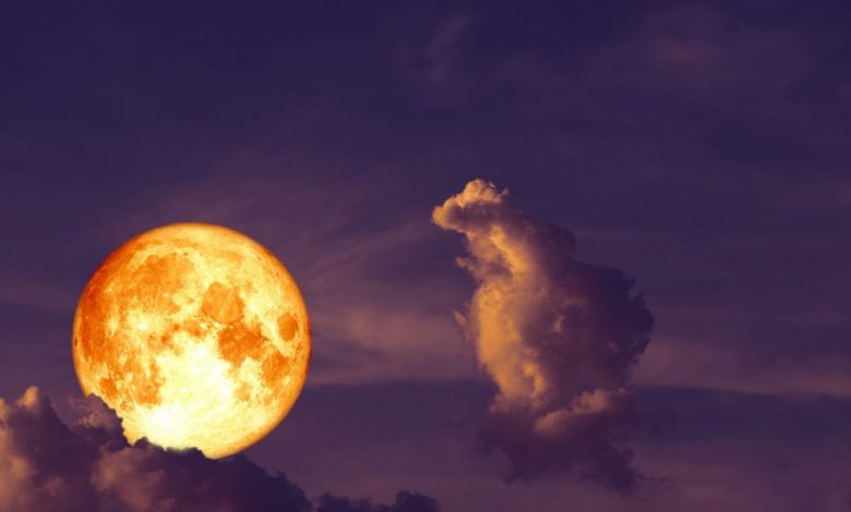 An image of a super moon among the clouds. Artist's rendering. Shutterstock.