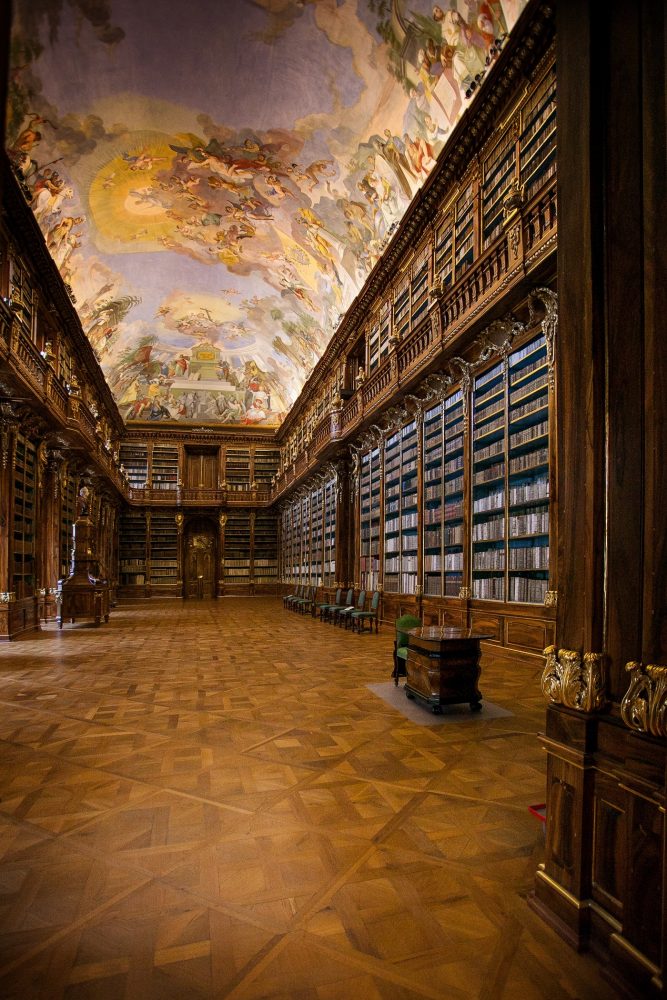 An image of the ceiling and books of the Clementinum Library. It offers a unique combination of art and literature. Shutterstock.