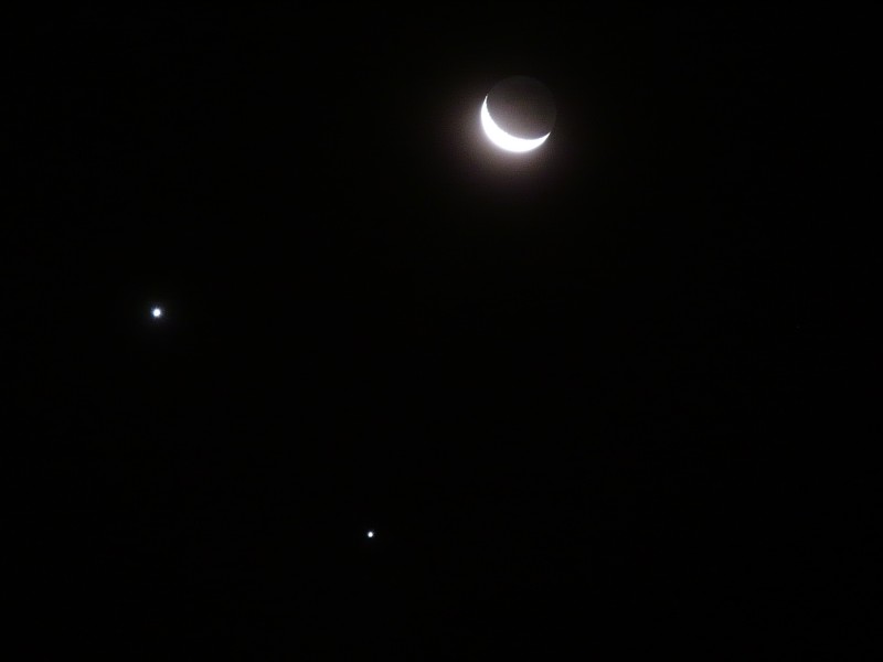 An image of a cosmic conjunction of Venus (left) and Jupiter (bottom), with the nearby crescent Moon, seen from São Paulo, Brazil, on 1 December 2008. Image Credit: Wikimedia Commons.