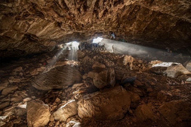 An image showing scientists exploring the Chiquihuite Cave, located in a mountainous area in northern Mexico. Image Credit: Devlin A. Gandy.