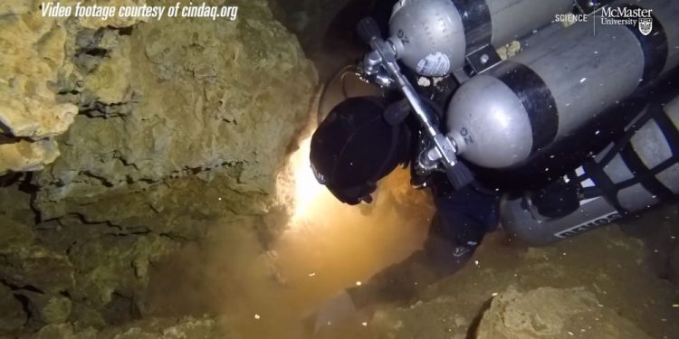 A screenshot showing a diver exploring the now sunken ochre mine in Quintana Roo, Mexico. Image Credit: McMaster University / Vimeo.