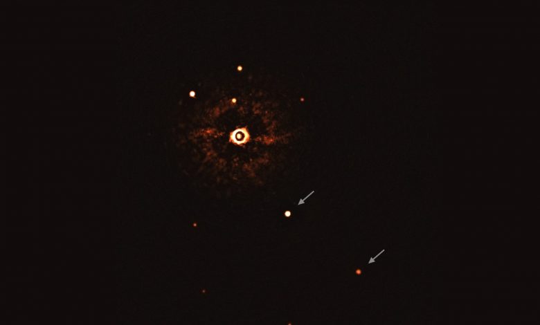 This image, captured by the SPHERE instrument on ESO’s Very Large Telescope, shows the star TYC 8998-760-1 accompanied by two giant exoplanets. Image Credit: ESO/Bohn et al.