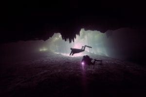 An image of divers exploring a sunken site. Shutterstock.