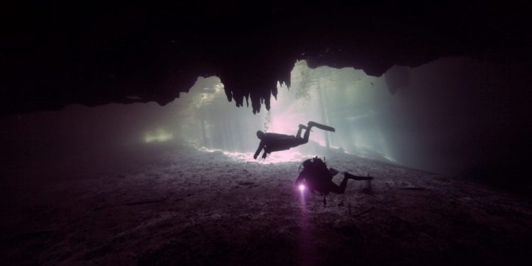 An image of divers exploring a sunken site. Shutterstock.