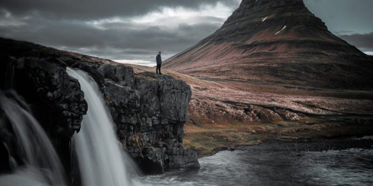 A stunning long exposure photograph of a waterfall in Iceland. Jumpstory.