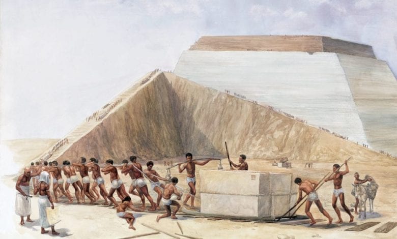 An artist's illustration showing the builders of the pyramids hauling massive blocks of stone up a ramp.