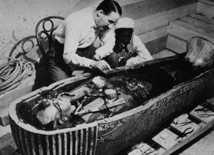 The famous photograph of Howard Carter when he opened the coffins of Tutankhamun.