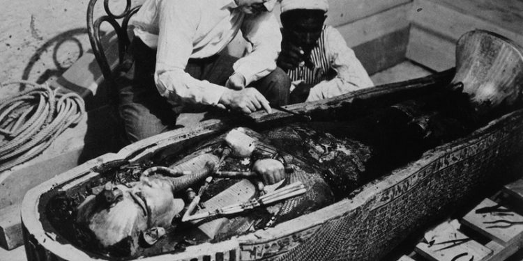 The famous photograph of Howard Carter when he opened the coffins of Tutankhamun.