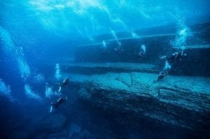 Divers exploring the Yonaguni monument near the base level.