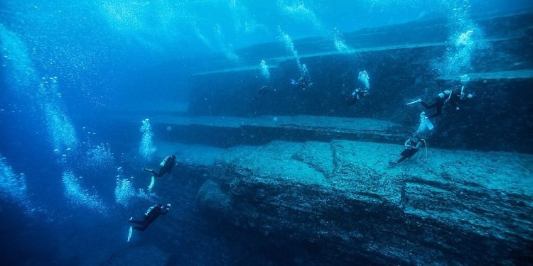 Divers exploring the Yonaguni monument near the base level.