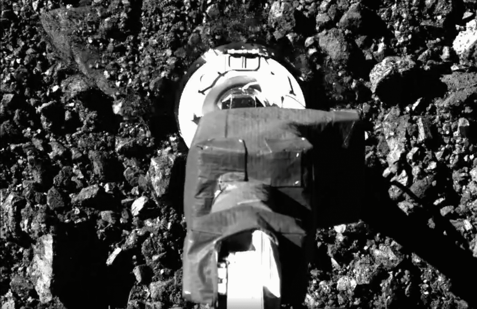 SamCam view of the sampling event on asteroid Bennu. Image Credit: NASA.