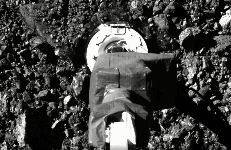 SamCam view of the sampling event on asteroid Bennu. Image Credit: NASA.
