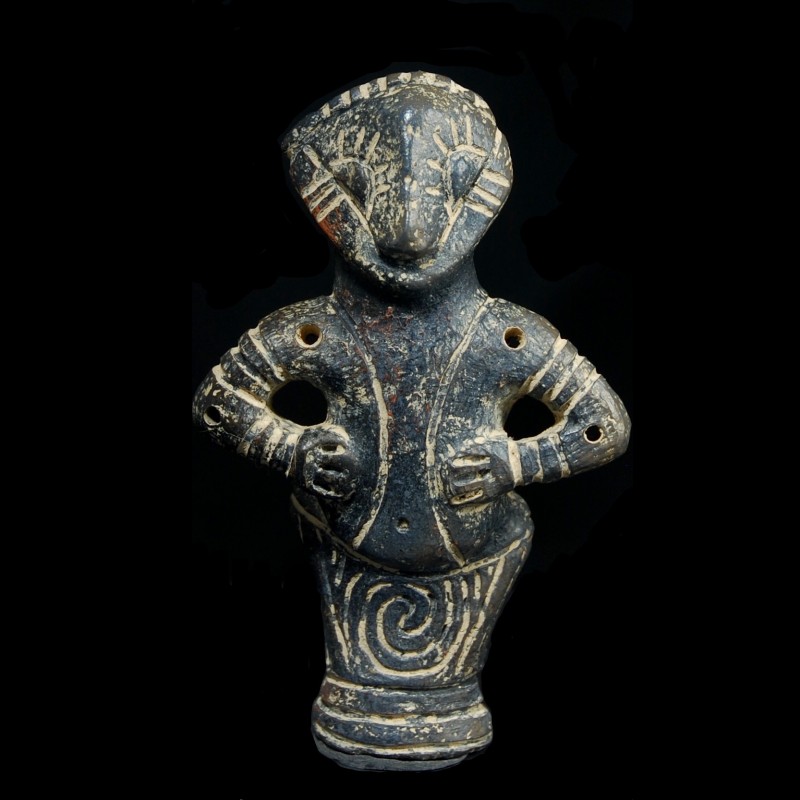 Vinca figurine depicting a woman wearing a long dress. 