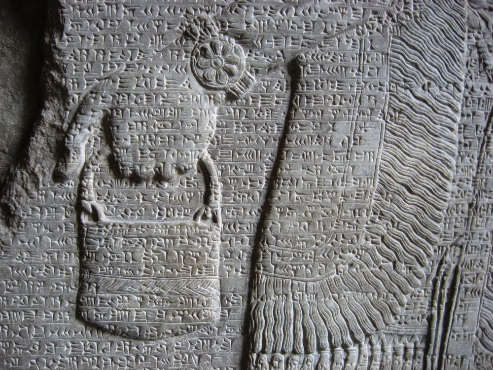 An ancient sumerian illustration of a deity carrying a "bag." Jumpstory.