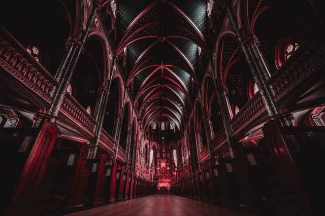 The interior of a cathedral with red color. Jumpstory.