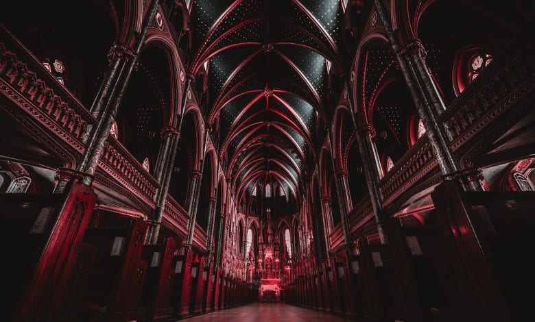 The interior of a cathedral with red color. Jumpstory.