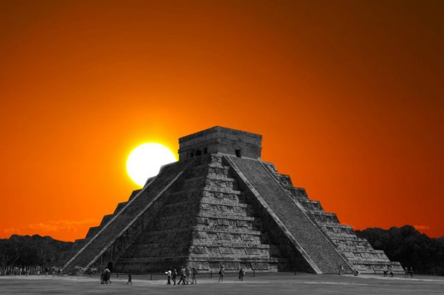 The sun rising behind the step pyramid in Chichen Itza, one of the many ancient monuments around the world built to align with the sun on the days of the solstices.