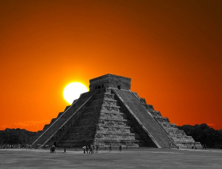 The sun rising behind the step pyramid in Chichen Itza, one of the many ancient monuments around the world built to align with the sun on the days of the solstices.