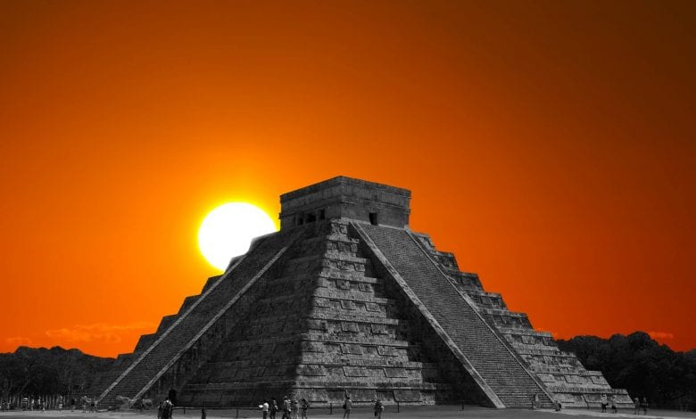 The sun rising behind the step pyramid in Chichen Itza, one of the many ancient monuments around the world built to align with the sun on the days of the solstices.