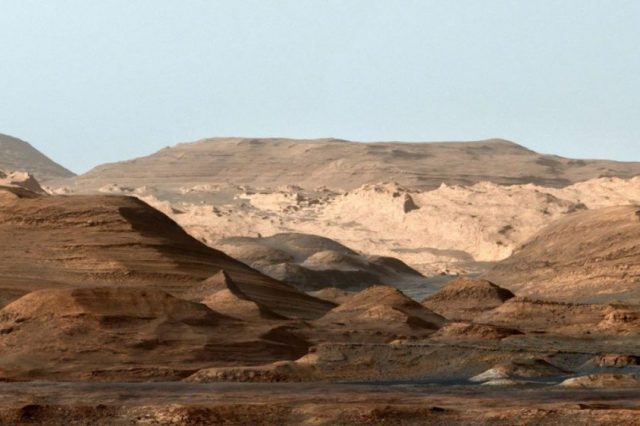 False-color image of Mount Sharp from inside the Gale Crater showing the everchanging planetary environment. Note that the sky is not blue on Mars but it was done deliberately to enhance the researchers' ability to distinguish the different stratification layers. Credit: NASA/JPL